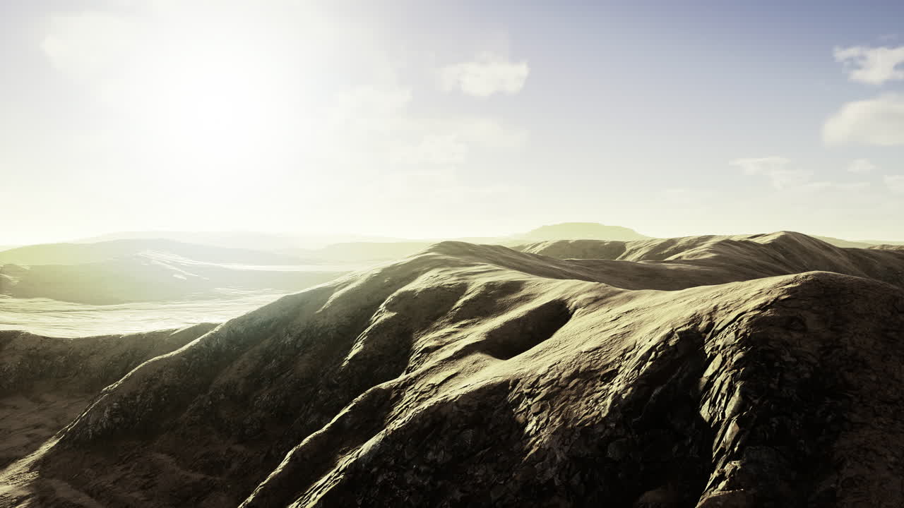 Breathtaking view of rolling hills under a soft golden sunlight