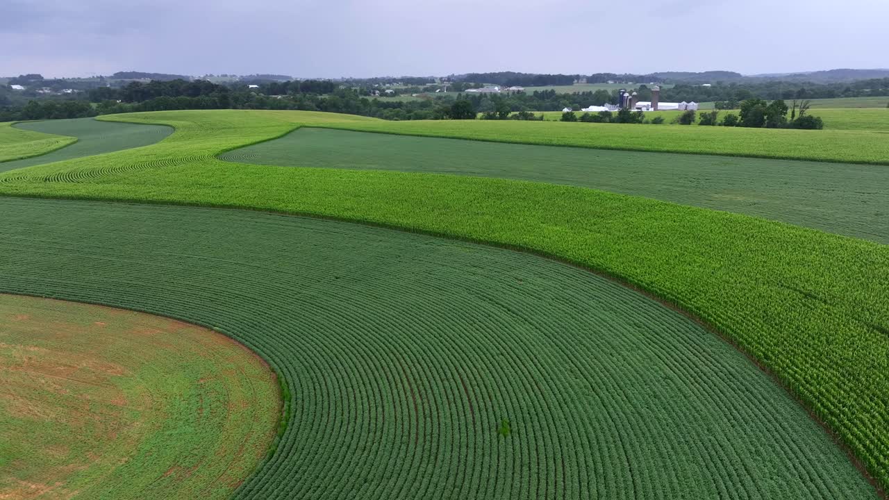 Drone flight over different farm field plantation in america during thunderstorm