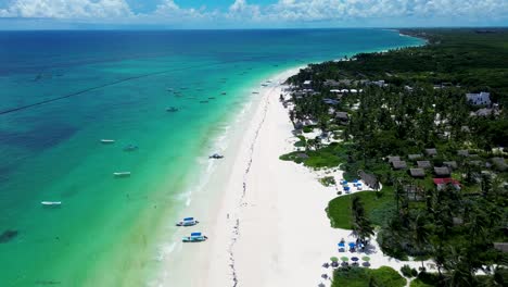 drone aerial of boats docked on sandy ocean beach of tulum ruins headland coastline rainforest quintana roo mexico central america travel holidays tourism