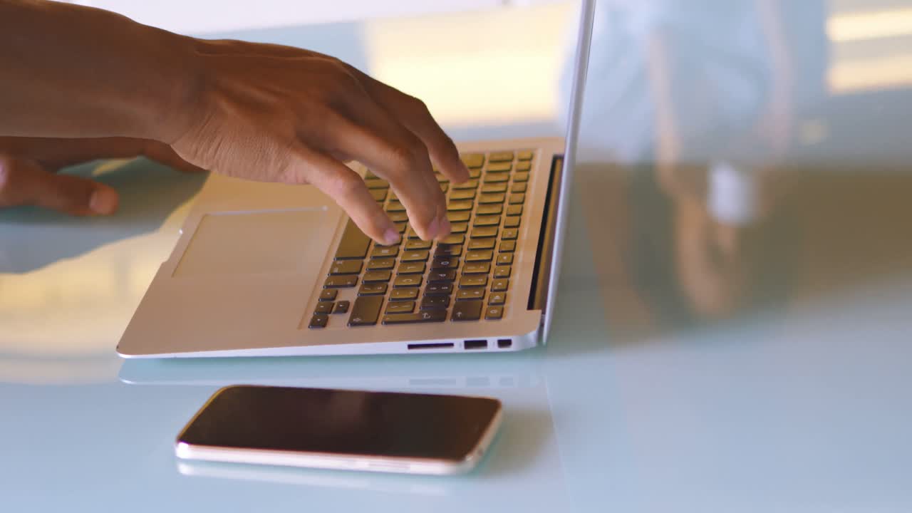 Man using laptop in kitchen 4k