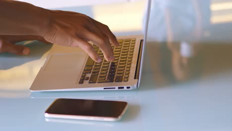 Man-using-laptop-in-kitchen-4k