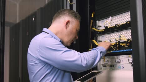 technician using laptop to analyse server