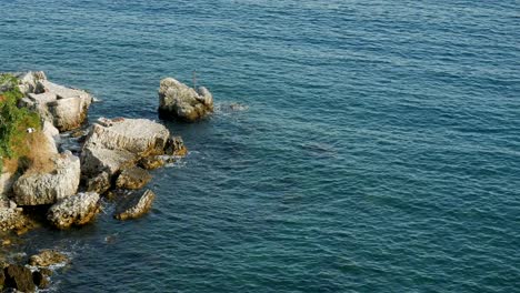 waves beating on the rocks on the beach in montenegro