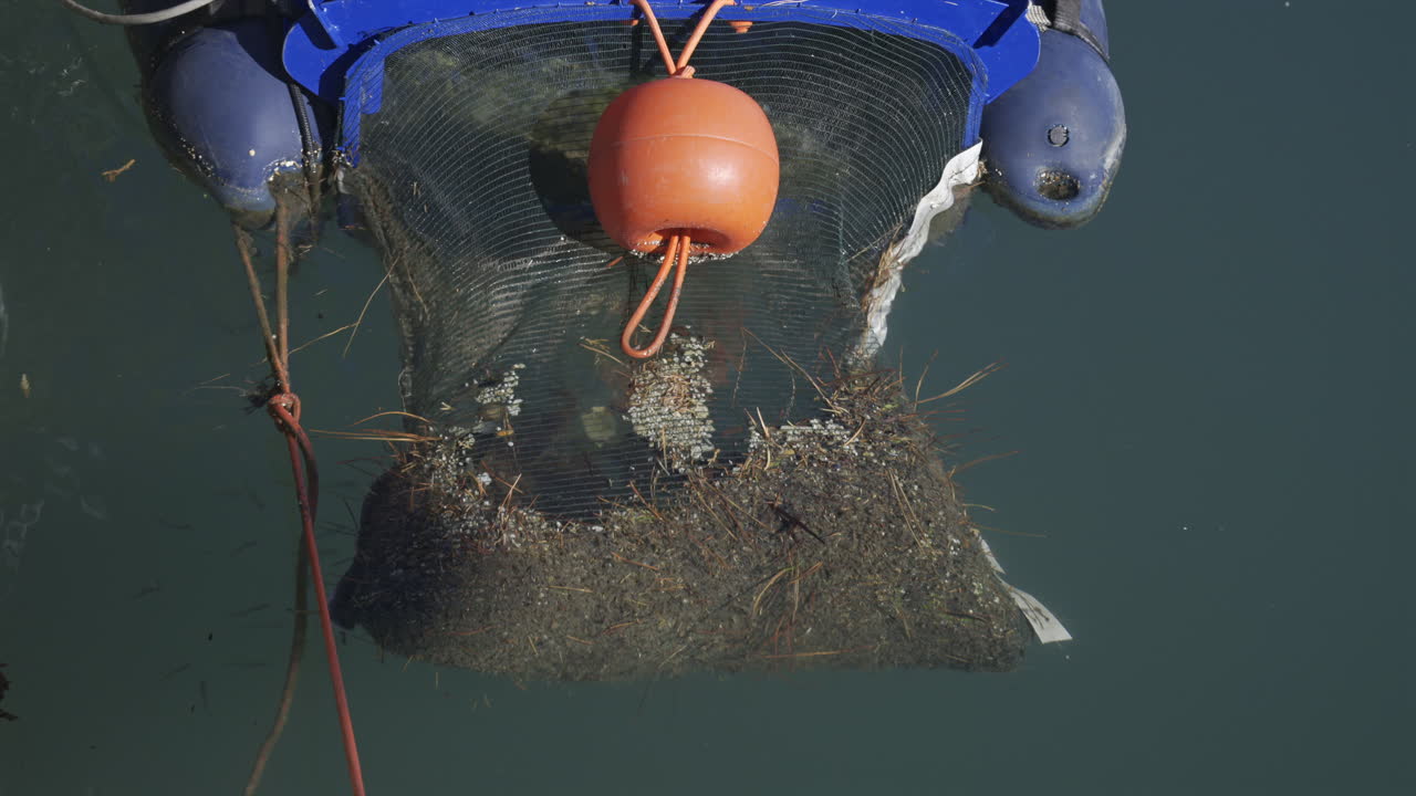 Close up of a floating marine debris collection device in the water