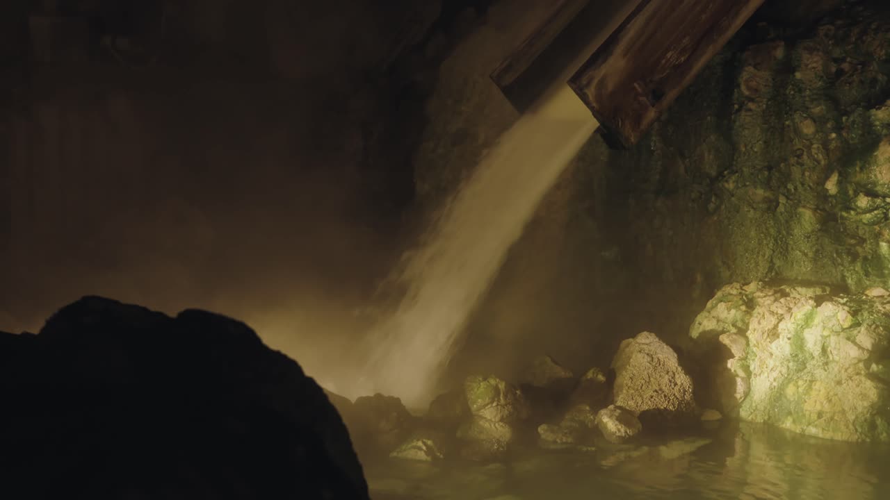 Discover the iconic Yubatake waterfall in Kusatsu Onsen, Japan, cascading with mineral-rich hot spring water that steams into the crisp mountain air.