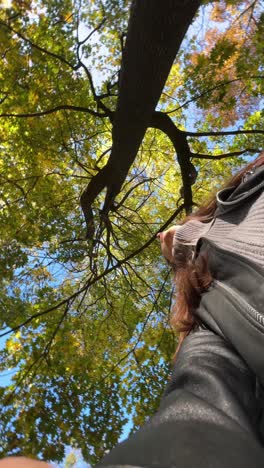 woman under a tree in autumn