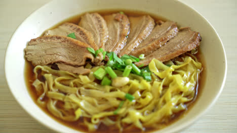 egg noodles with stewed duck in brown soup - asian food style