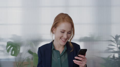 portrait-young-happy-red-head-business-woman-using-smartphone-video-chatting-waving-hand-blow-kiss-enjoying-mobile-phone-communication-smiling-cheerful-slow-motion