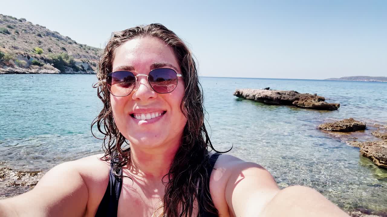 Young Woman Tourist Vlogging Her Sunny Beach Vacation in Greece