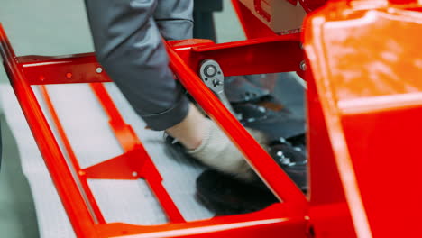 worker using universal socket wrench working in assembly workshop