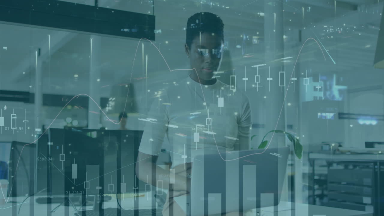 Businessman working on laptop with financial data charts overlay animation