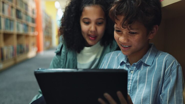 Children using a tablet in a library