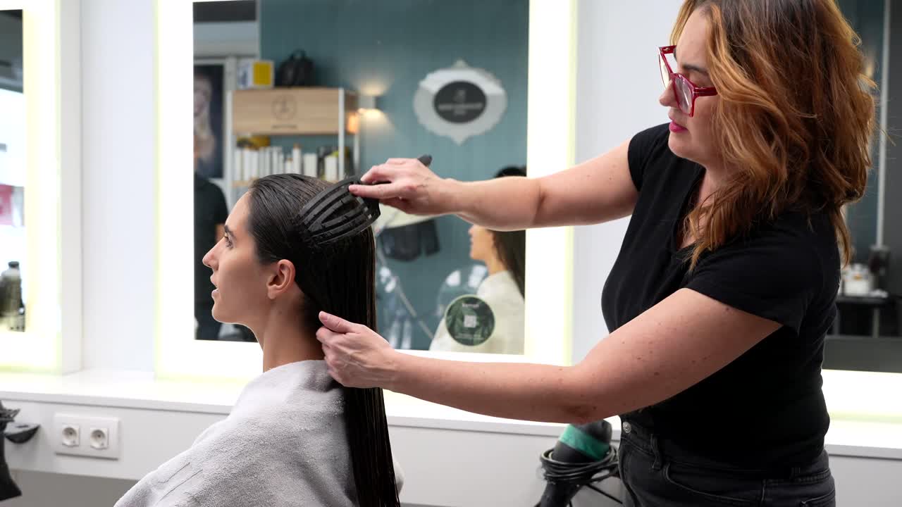 Hairdresser styling wet hair in a salon