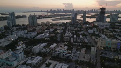 drone aerial miami south beach ocean drive avenue road at sunset city skyline florida usa