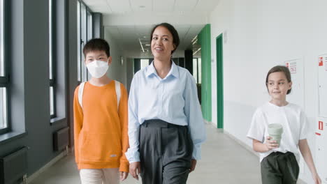 teacher and pupils walking through the corridor.