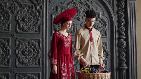 couple in traditional clothing with grapes