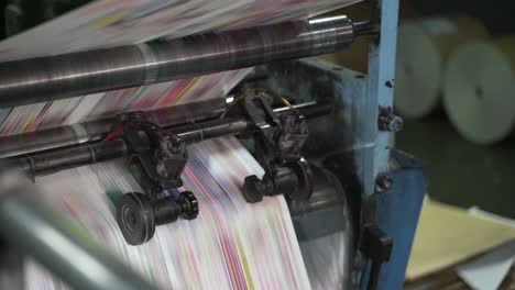 color printing of newspapers on large machines, conveyor. rolls of paper are drawn across the printing press. printing house. media, article, headline, daily news, print edition, journalism, politics