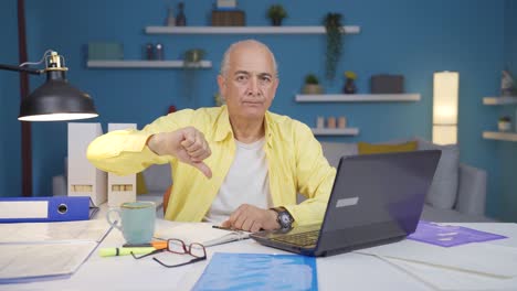 home office worker old man making negative gesture at camera.