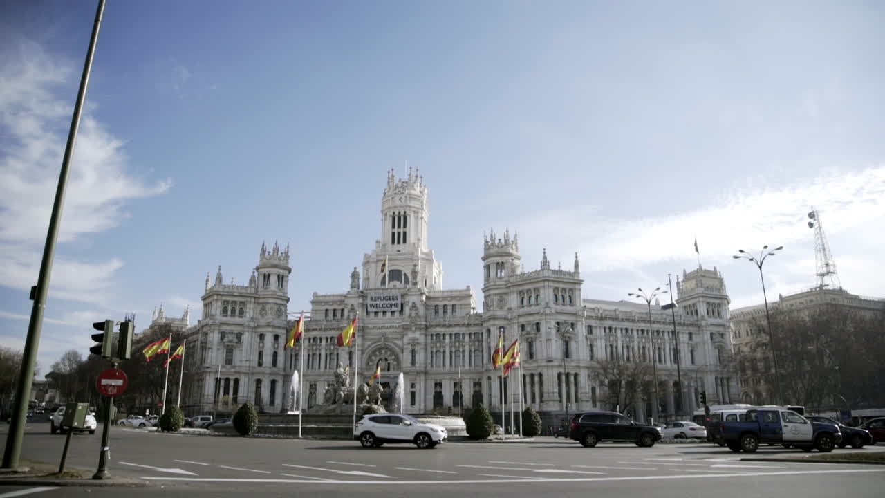 Madrid Cityscape: Plaza de Cibeles with Welcome Refugees Banner