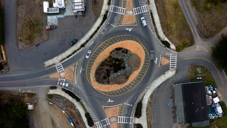 aerial top view of a small town roundabout on highway one