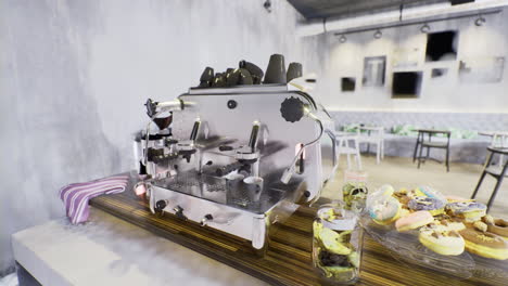Coffee brewing station at a modern cafe with a display of colorful pastries
