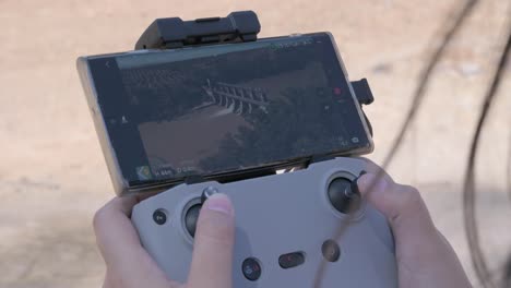 close-up of a remote control drone with a view of a dam on a river