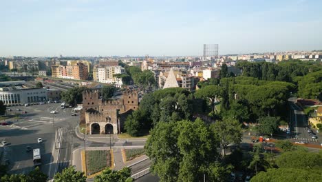 Aerial-Boom-Shot-Reveals-Porta-San-Paolo-and-Pyramid-of-Caius-Cestius-in-Rome,-Italy