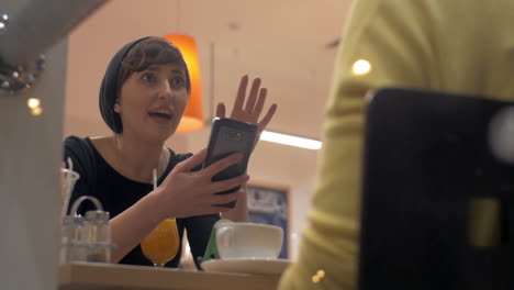 Female-friends-meeting-in-cafe-and-gossiping