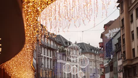 festive bright christmas lights on main shopping street at festive christmas market in strasbourg, france europe