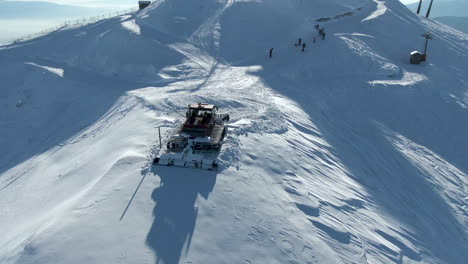 Snow-groomer-parked-on-top-of-slopes-at-ski-resort