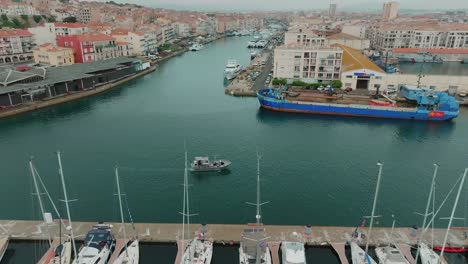 aerial tracking shot of a scientific boat returning to sete port after an project