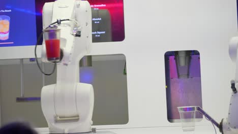 robotic arm pours liquid into glass purple and violet an electronic device in purple and magenta skillfully pours liquid into a glass through a robotic arm near a violet window