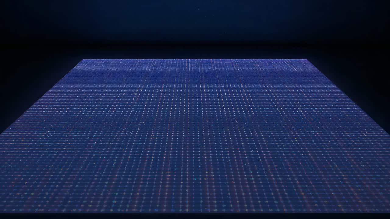 Receiving power, large LED panel showing slight blue purple dot shimmer in dark studio