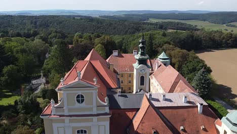 drone is flying passing by a church tower from above