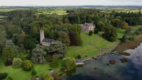 aerial view of a historic estate with church and mansion