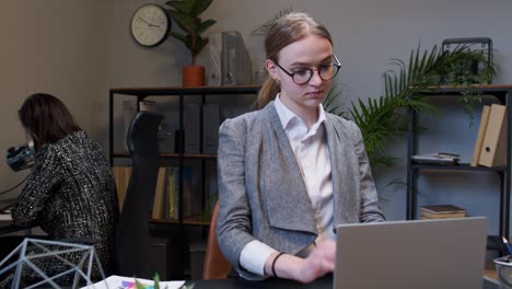 young business woman freelancer concentrated developing new project while looking on laptop screen