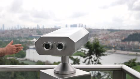 binoculars at an observation point with city view