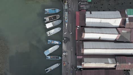 waterfront boardwalk pier, boats, warehouses in georgetown malaysia