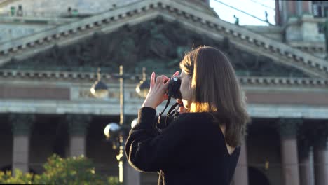 woman taking picture of historical building