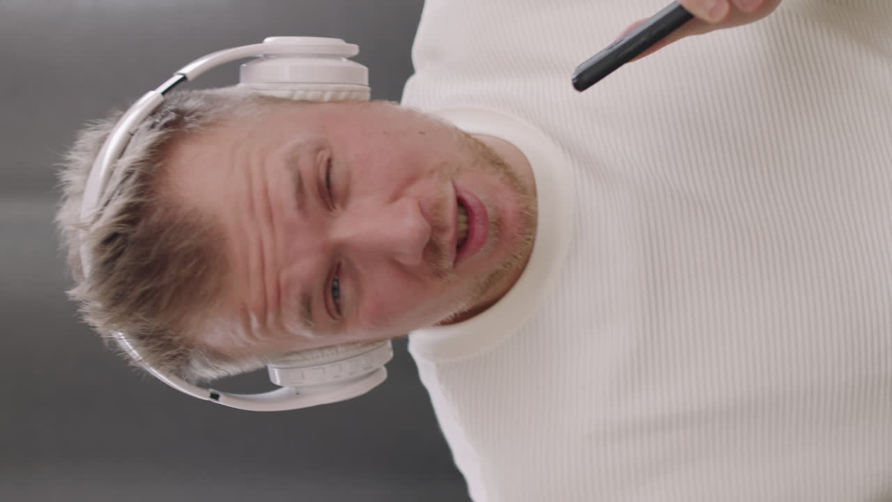Vertical Close Up of Man in Headphones Singing