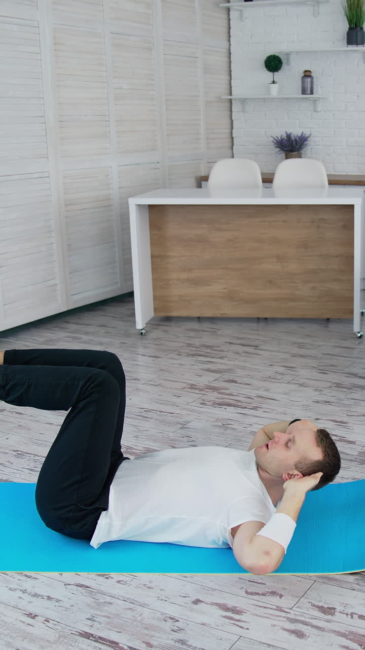 Man training indoor on lockdown time. Sporty lifestyle active man training his body. Vertical video