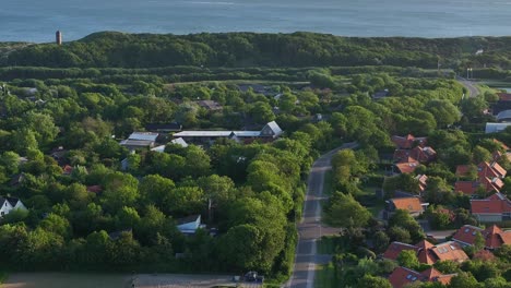 Verdant-trees-and-farms-of-Zoutelande-roll-by-in-this-slow-drone-shot