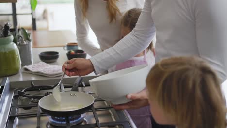 family preparing food in kitchen at home 4k