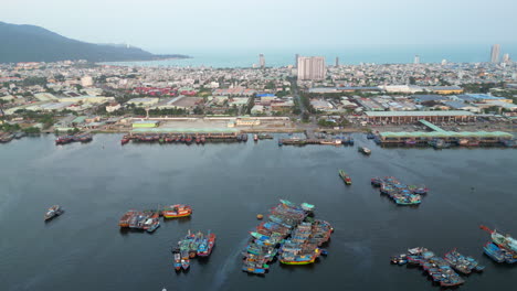 drone pull back over danang harbour with fishing boats below in vietnam