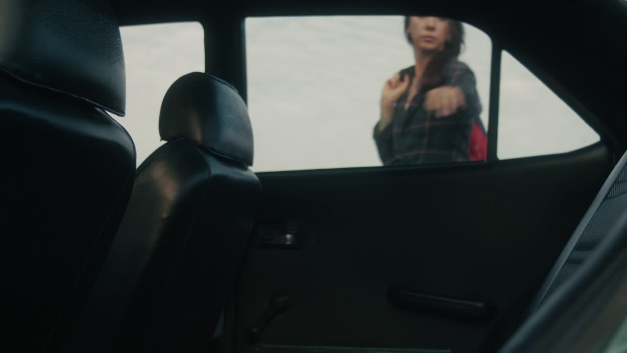 Person Getting Out of Car with Surf Gear