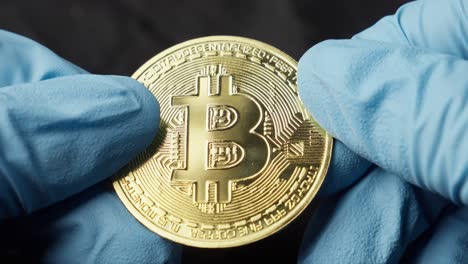 Hand-In-Gloves-Showcasing-Bitcoin-Gold-Coin