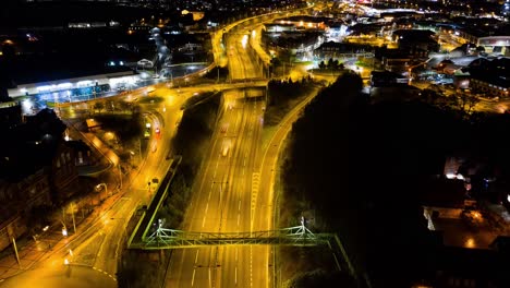 An-aerial-view-of-a-night-time-time-lapse,-timelapse-of-the-A50,-A500-dual-carriage-way,-motorway-in-the-heart-of-the-midlands-area-of-Stoke-on-Trent,-Staffordshire