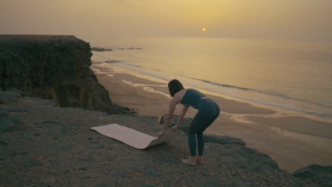 yoga sunset session on coastal cliff