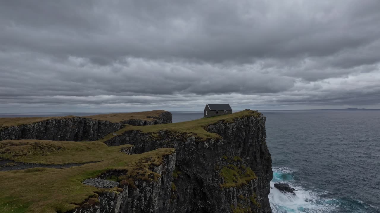 Lone house sits atop a rugged cliff overlooking a turbulent sea under a moody, overcast sky. The scene captures the essence of isolation and the raw power of nature