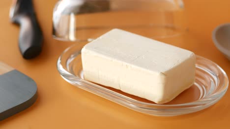 a stick of butter in a butter dish